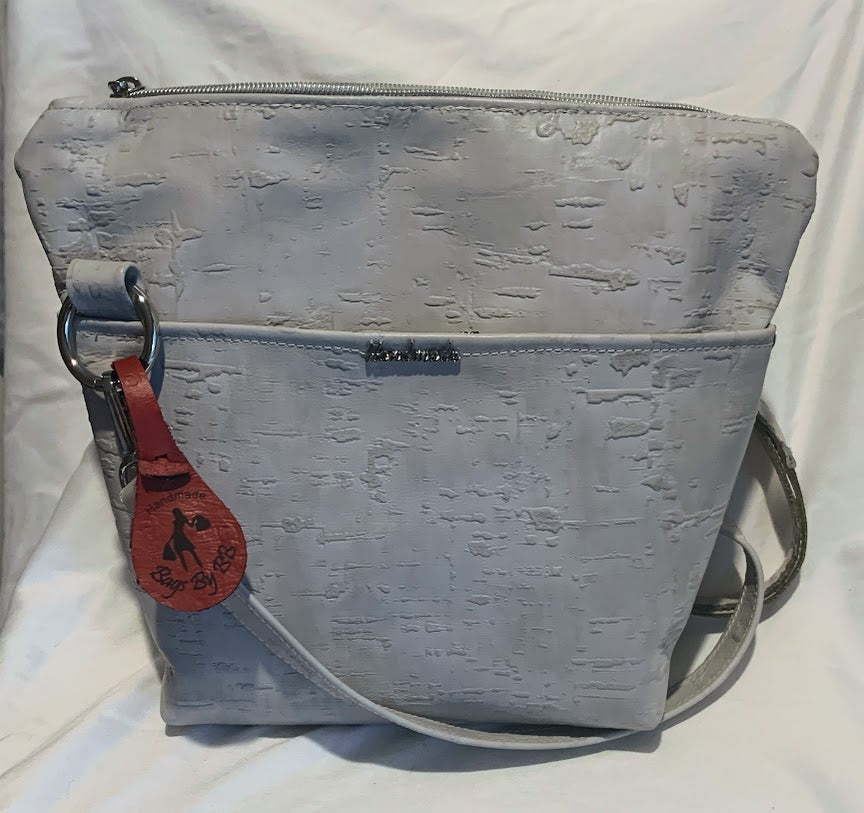 Embossed , cream colored leather crossbody