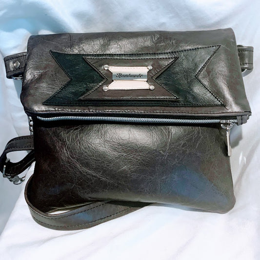 Gray leather fold over bag with adjustable crossbody strap