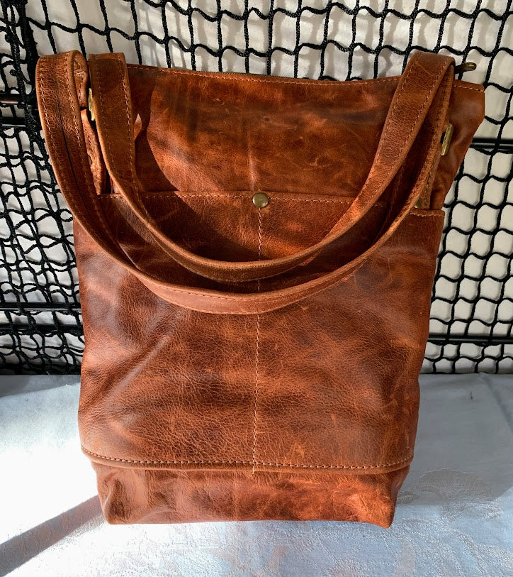 Distressed caramel colored leather tote