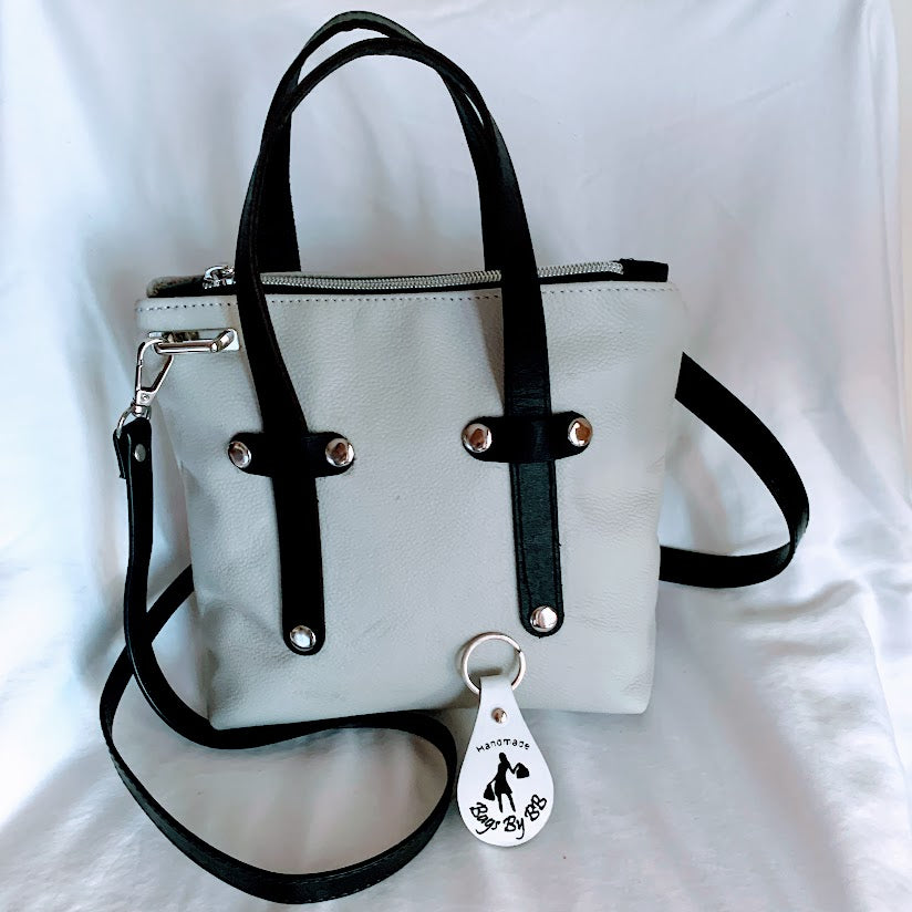 Cream colored leather mini tote with black leather enhancements