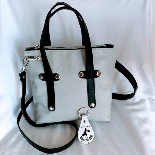 Cream colored leather mini tote with black leather enhancements