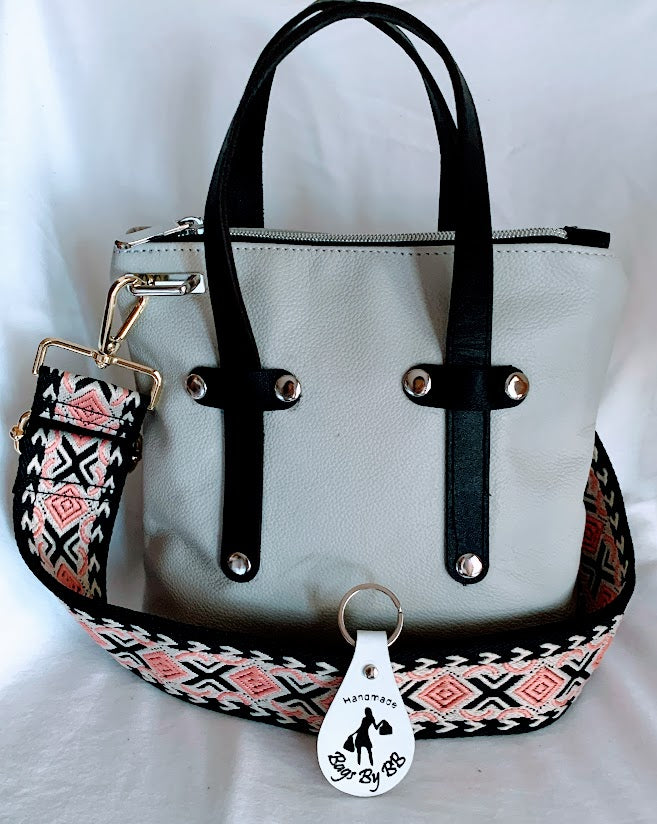 Cream colored leather mini tote with black leather enhancements