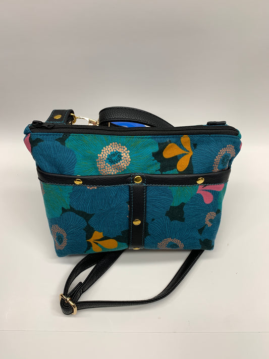 Colorful canvas crossbody bag with adjustable strap and leather trim.