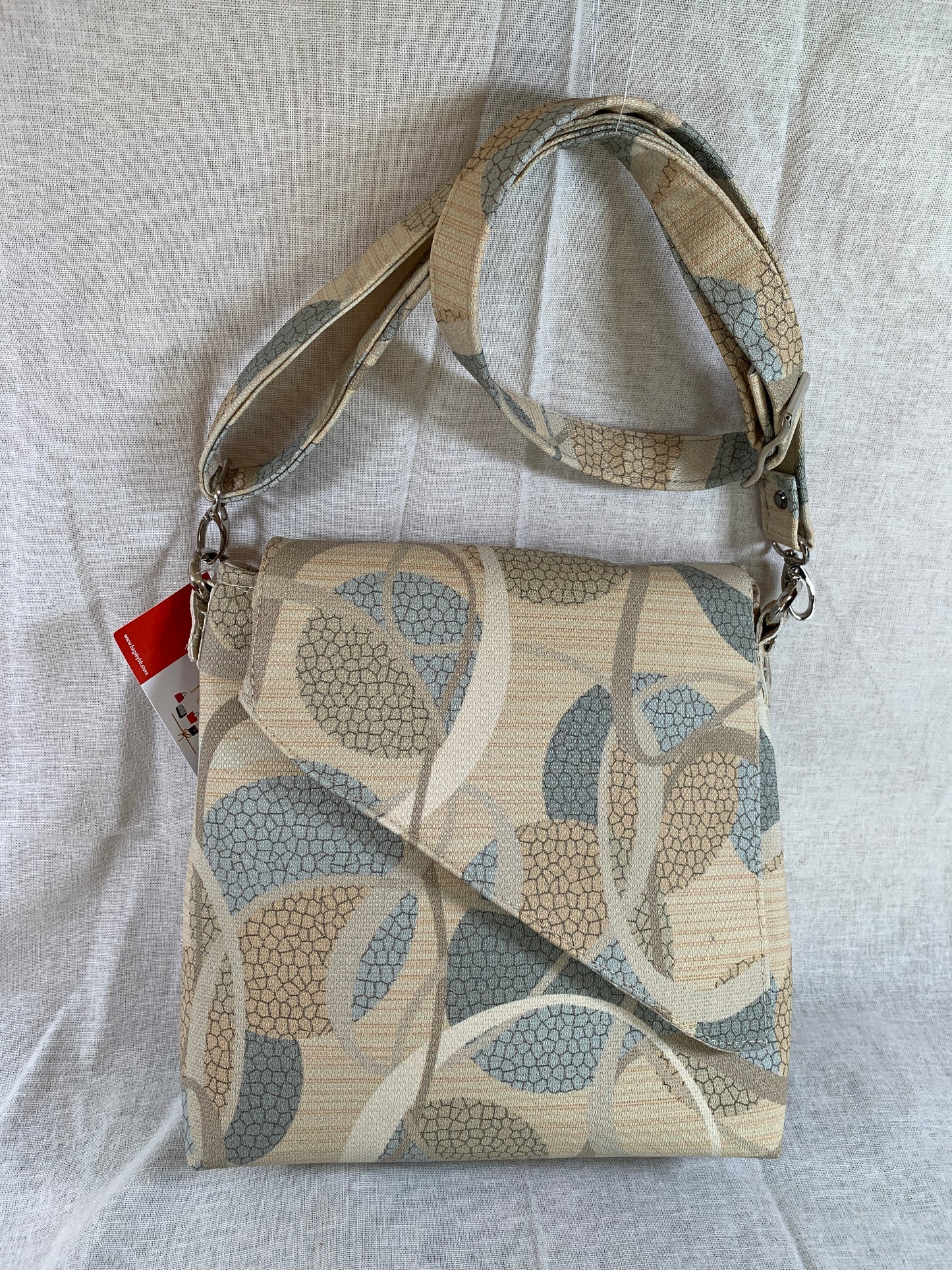 Both attractive and practical , this designer vinyl crossbody will take you anywhere.