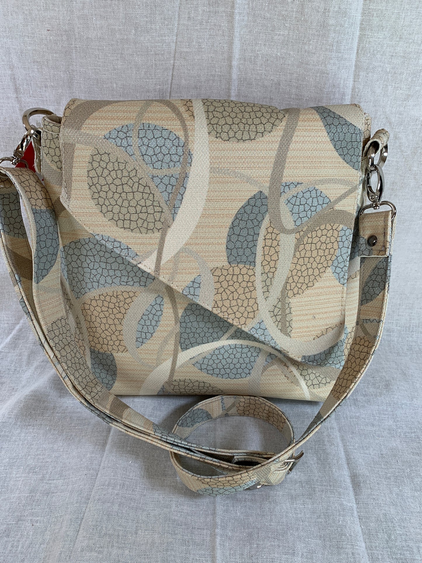Both attractive and practical , this designer vinyl crossbody will take you anywhere.