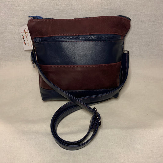 Classically designed all leather crossbody bag with burgundy and navy stripes.