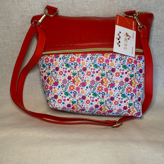 Colorful vinyl crossbody with two large exterior zipper pockets.
