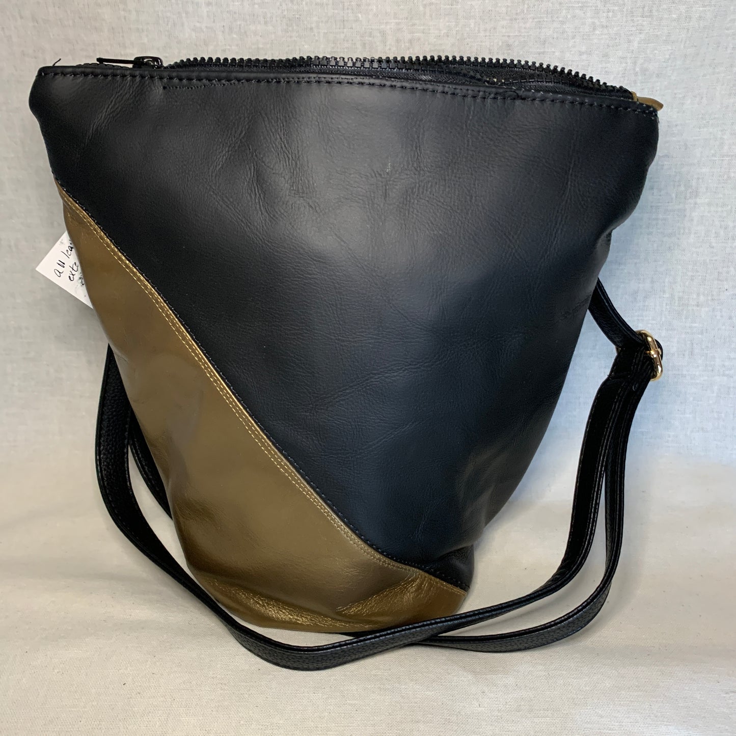 Beautiful black and gold all leather bag with adjustable crossbody strap.