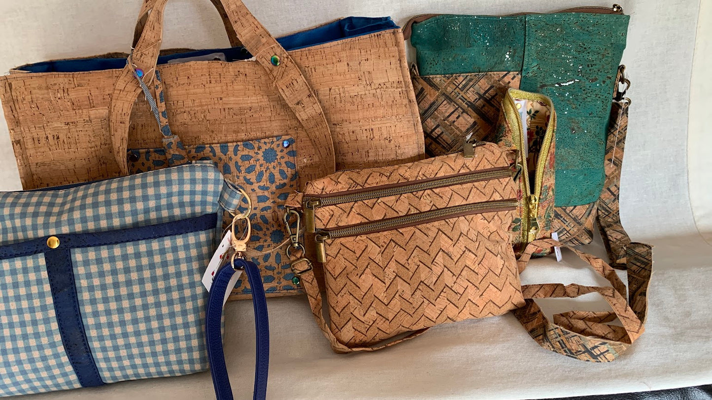 All cork mini crossbody with three exterior zippers.