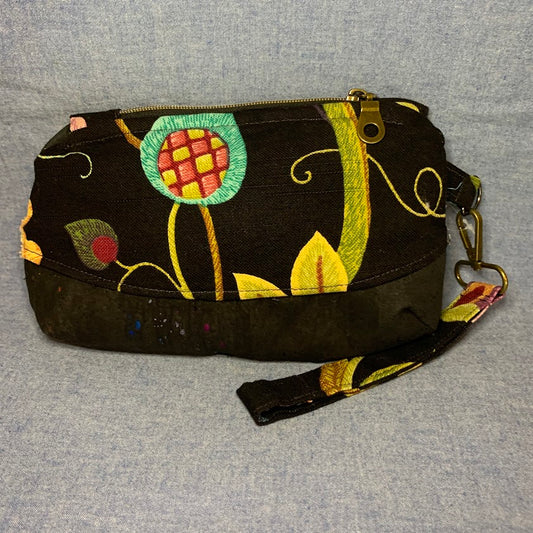 Home décor fabric brightens the black background of this wristlet.