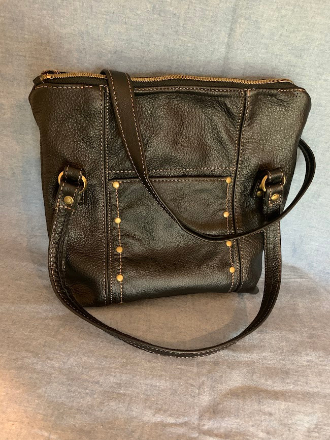 Black leather tote with two external slip pockets and fashion rivets to detail pocket