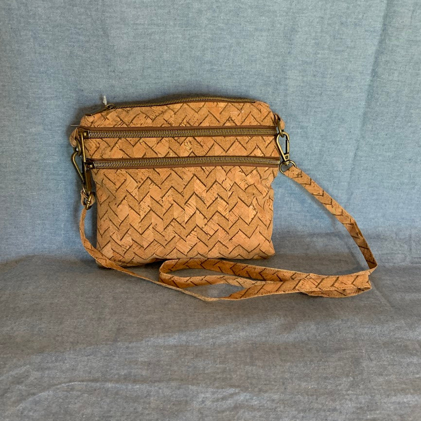 All cork mini crossbody with three exterior zippers.