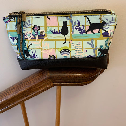The cat lover's pouch with leather trim and canvas body.