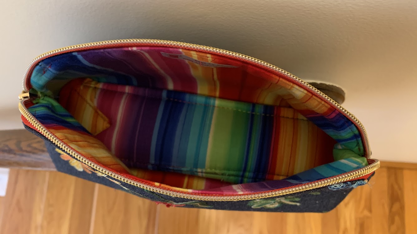 The pouch for all seasons: embroidered denim outside and striped canvas inside