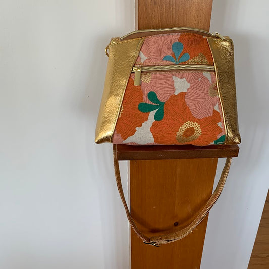 Beautiful leather and canvas crossbody with gold hardware.