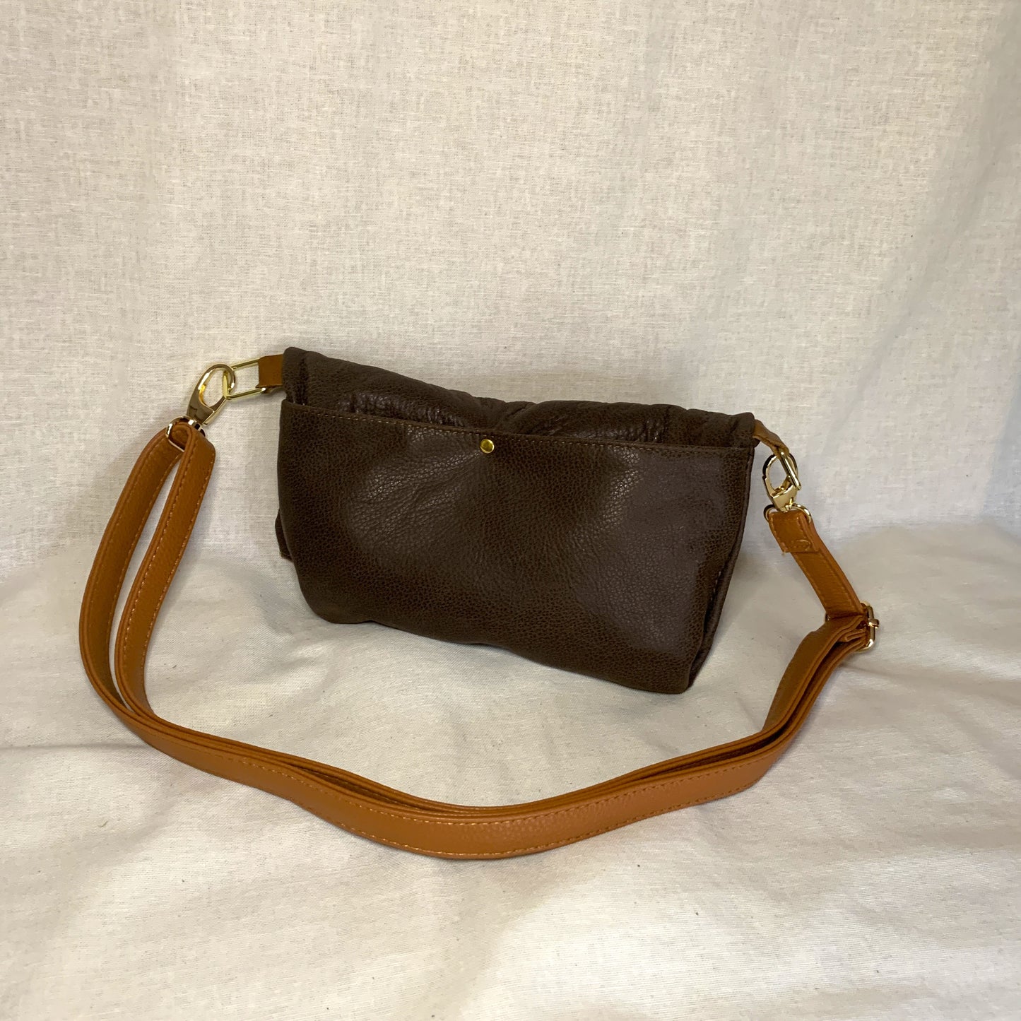 All leather small fold over crossbody  bag with two external pockets and interior zip pockett.