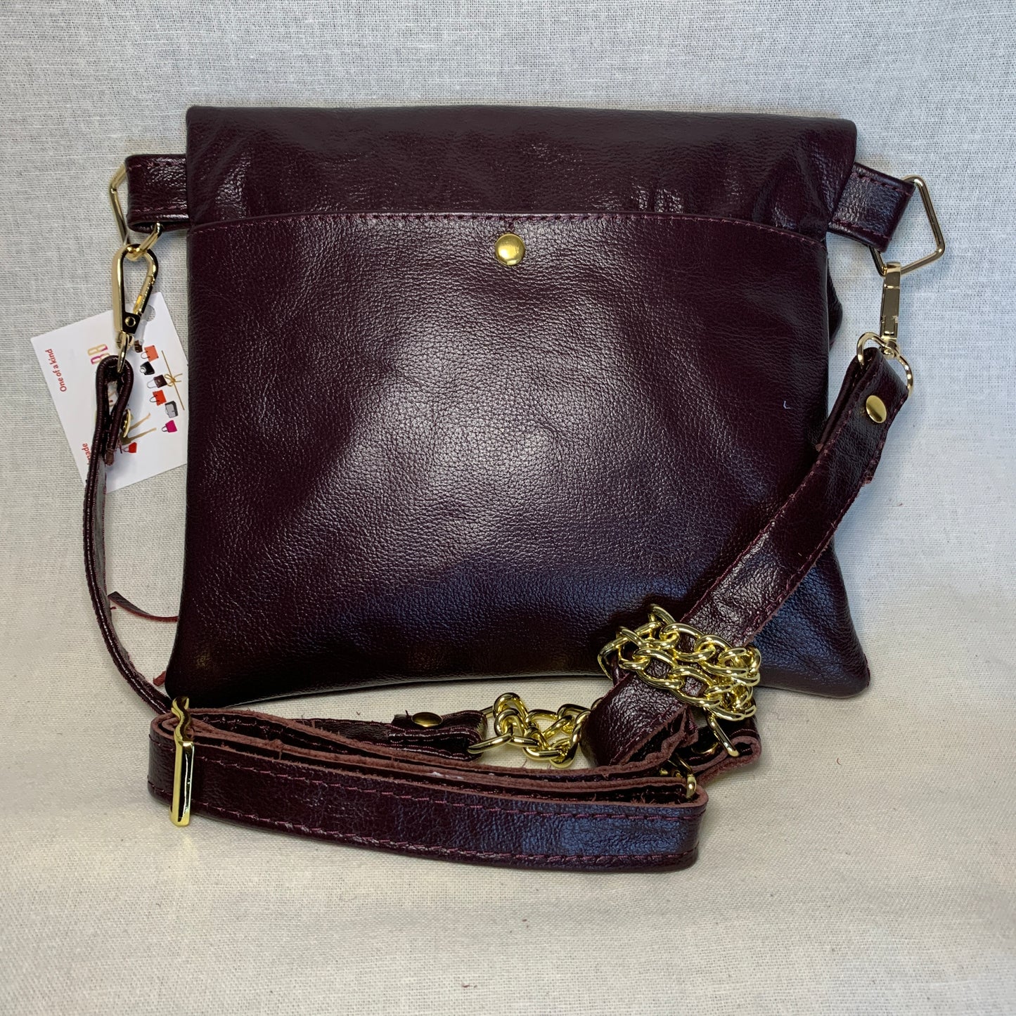 Fold over crossbody in wine colored leather.